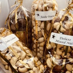Clear bags of assorted nuts with gold foiling on the edges