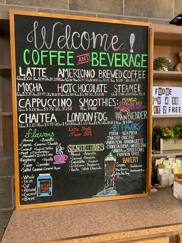 Chalkboard coffee menu with coffee flavors listed in chalk