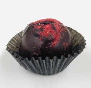 Dark chocolate truffle with raspberry red sprinkles on top